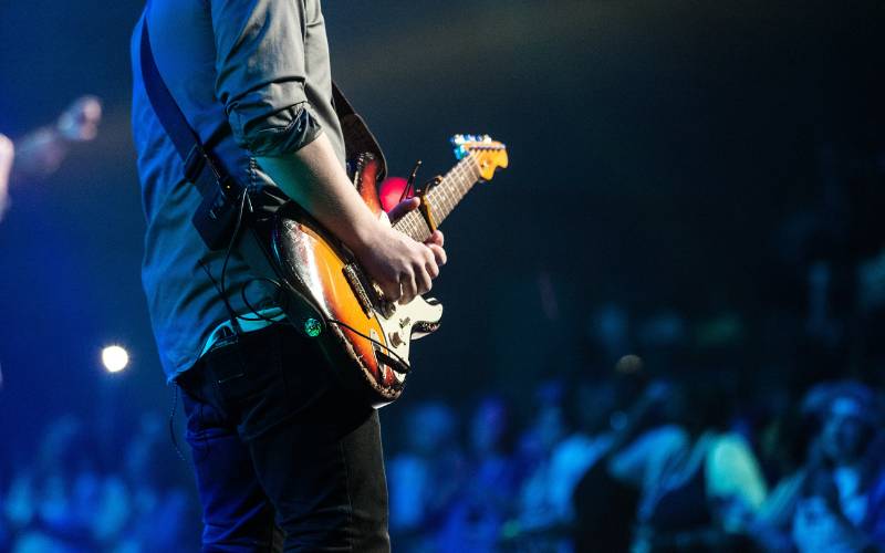 How to become a musician - a guitarist on the stage in front of a crowd